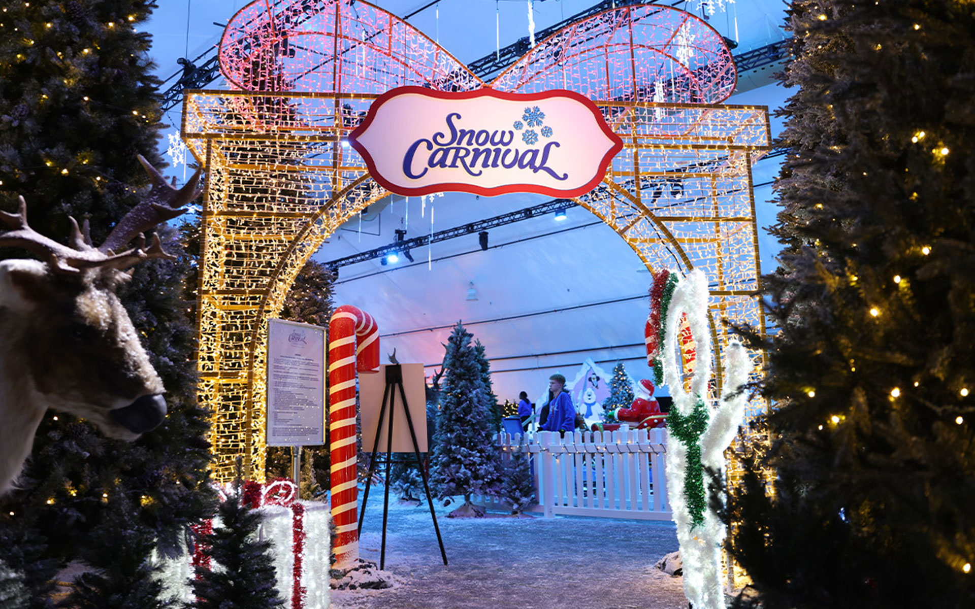 Entrance of a snow carnival featuring themed winter attractions and immersive snow entertainment for visitors.