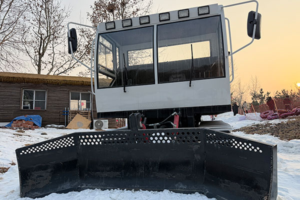 Front snowplow of a snow groomer designed for efficient snow clearing, shaping, and ski slope preparation.