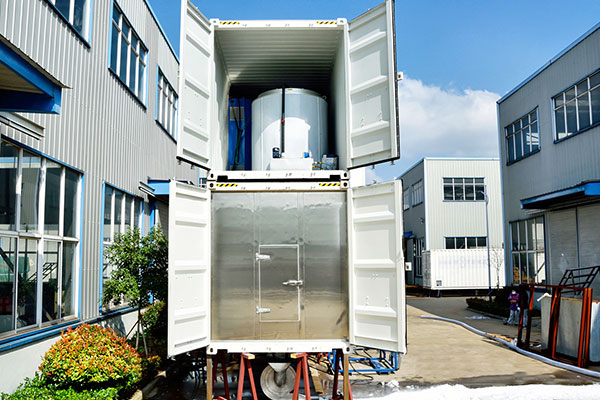 Interior of a containerized high-temperature snow making machine featuring an integrated refrigeration system, PLC controls, and snowmaking equipment.
