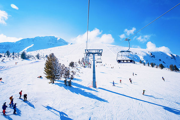 Outdoor ski resort equipped with advanced snowmaking systems, ski slopes, and winter sports facilities for skiing experiences.